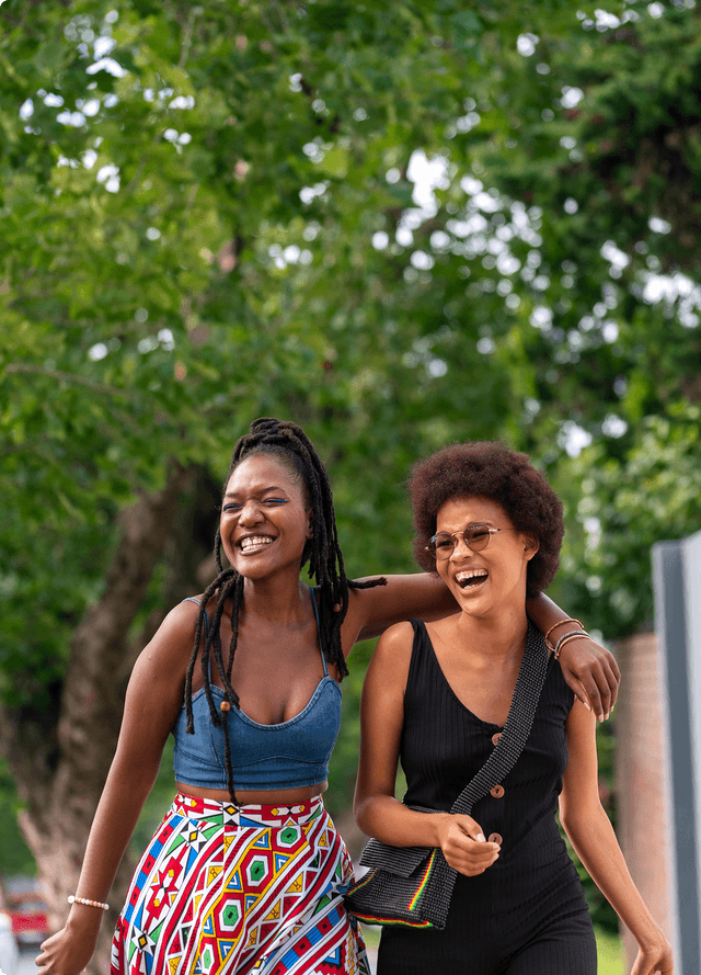 Two friends laughing together outdoors
